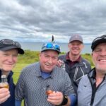 Karl Adam's group enjoying a wee dram on a Scottish links with EGT