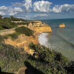 The golden limestone cliffs and sea stack of the Algarve coast in Portugal