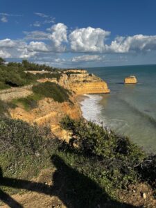 The golden limestone cliffs and sea stack of the Algarve coast in Portugal