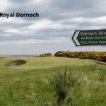 The 2nd green at Royal Dornoch beneath the course sign in the Highlands of Scotland