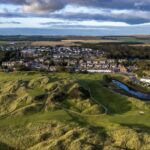 An aerial view of Cruden Bay Golf Club's dunes, the village and the river in Aberdeenshire, Scotland