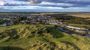 An aerial view of Cruden Bay Golf Club's dunes, the village and the river in Aberdeenshire, Scotland