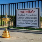 Ryder Cup trophy beside the warning sign at the Black Course at Bethpage