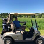 John E. Cone Jr., father of JP Cone, in a golf cart out on the course golfing with JP