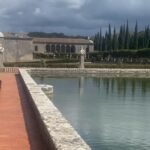 The great reflecting pool and formal gardens of a palace estate in Portugal, cypress trees behind