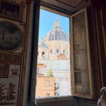 St Peter's Basilica dome seen through a window of the Vatican Museums, Rome