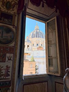 St Peter's Basilica dome seen through a window of the Vatican Museums, Rome