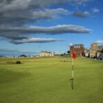 Red flag on the 18th green of the Old Course at St Andrews with the clubhouse behind, Scotland