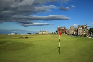 Red flag on the 18th green of the Old Course at St Andrews with the clubhouse behind, Scotland