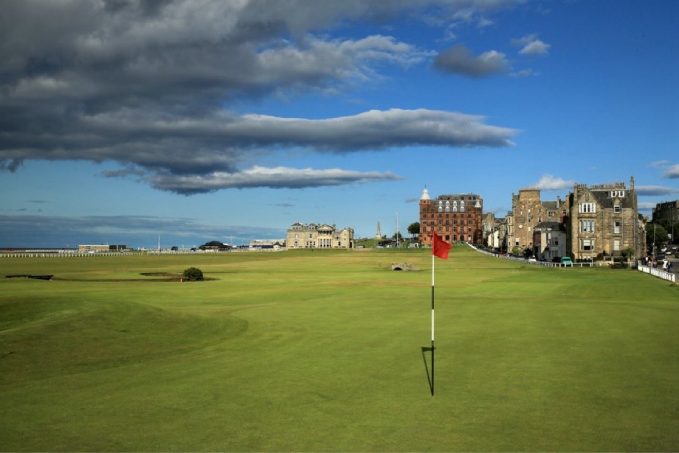 Red flag on the 18th green of the Old Course at St Andrews with the clubhouse behind, Scotland