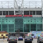 Old Trafford, home of Manchester United, with the United Trinity statue