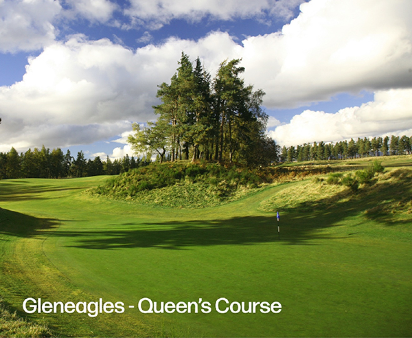 a links hole with a bunker and clubhouse at Hillside