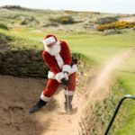 Santa Claus playing out of a bunker on an English links course