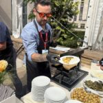 Freshly scraped raclette cheese being served in New York