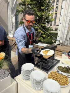 Freshly scraped raclette cheese being served in New York