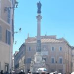 The Column of the Immaculate Conception in Piazza Mignanelli, near the Spanish Steps in Rome, on a busy summer day