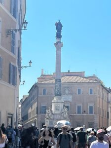 The Column of the Immaculate Conception in Piazza Mignanelli, near the Spanish Steps in Rome, on a busy summer day