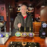 JP Cone behind the bar at the Rovers Return Inn on the Coronation Street set