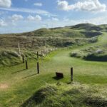 Golden evening light across an Irish links course