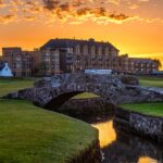 The Old Course Hotel at St Andrews silhouetted against a dramatic sunset sky, Scotland