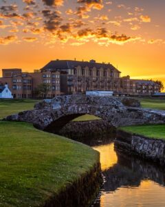 The Old Course Hotel at St Andrews silhouetted against a dramatic sunset sky, Scotland