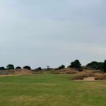 A wide links fairway under a big sky on England's Golf Coast