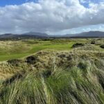 A bronze golfer statue on an Irish links