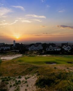 A links green at sunset beneath the houses of the Lancashire coast