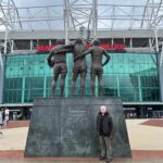 JP Cone beside the United Trinity statue outside Old Trafford