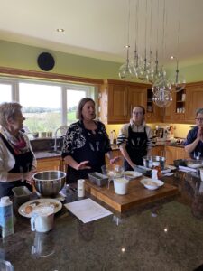 Guests learning traditional Irish baking at a country-house cookery class
