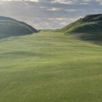 A links fairway framed by towering dunes in Ireland