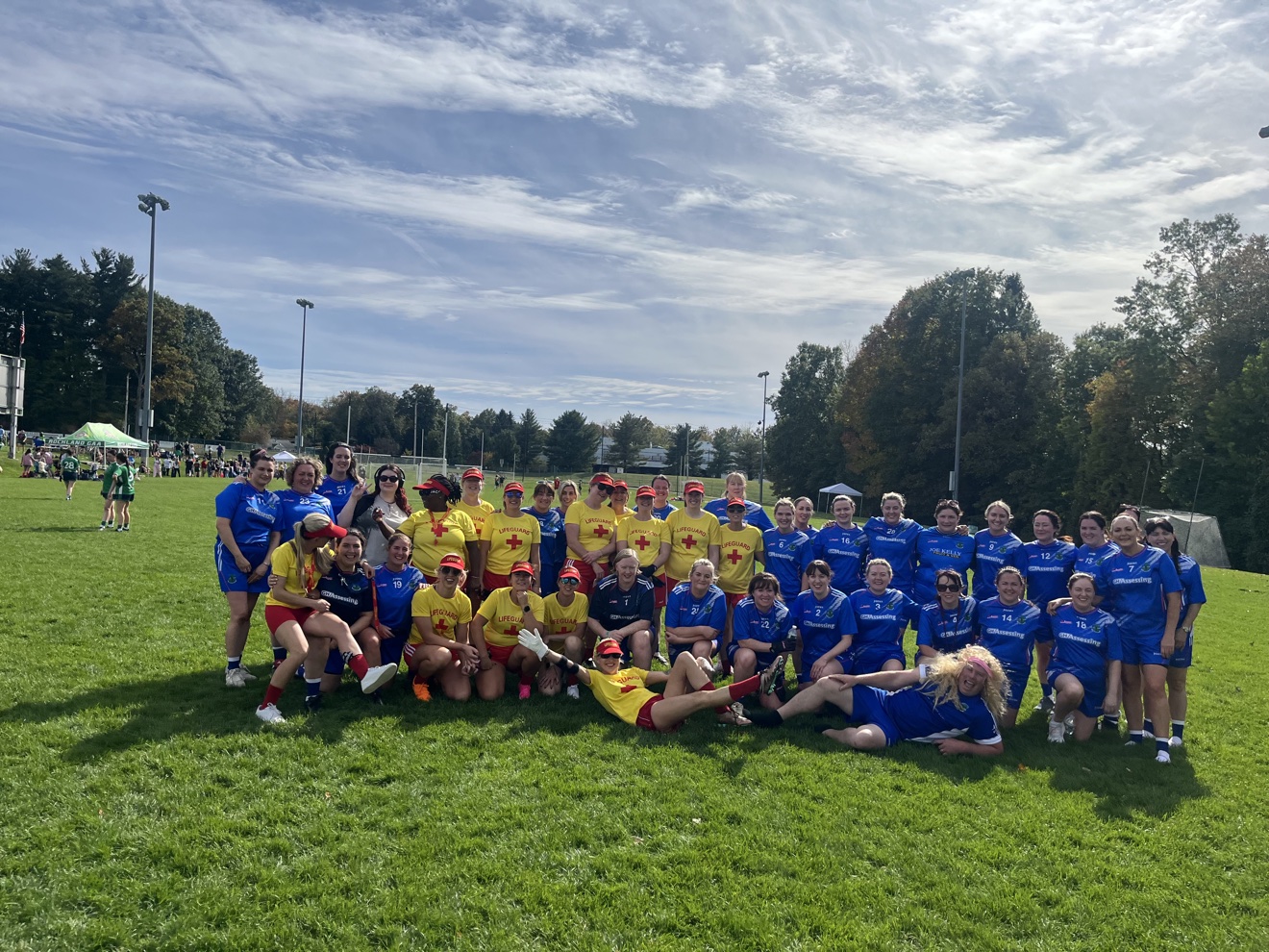 New York Ladies' Festival of Football — big joint team photo with a team in yellow shirts on the pitch at Rockland GAA