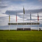 Royal Dornoch Golf Club entrance flags against dramatic sky, Scotland