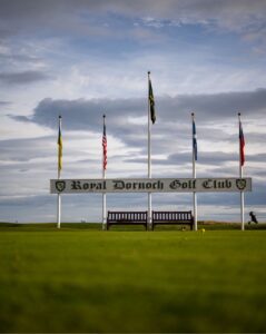 Royal Dornoch Golf Club entrance flags against dramatic sky, Scotland