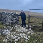 Man at Yorkshire dry stone wall