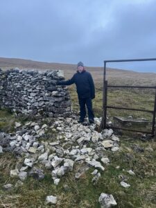 Man at Yorkshire dry stone wall