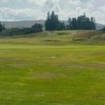 Rolling Scottish golf landscape with hills and bunkers