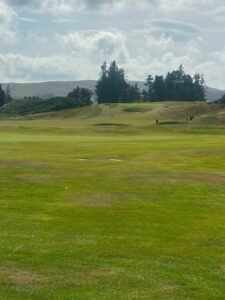 Rolling Scottish golf landscape with hills and bunkers