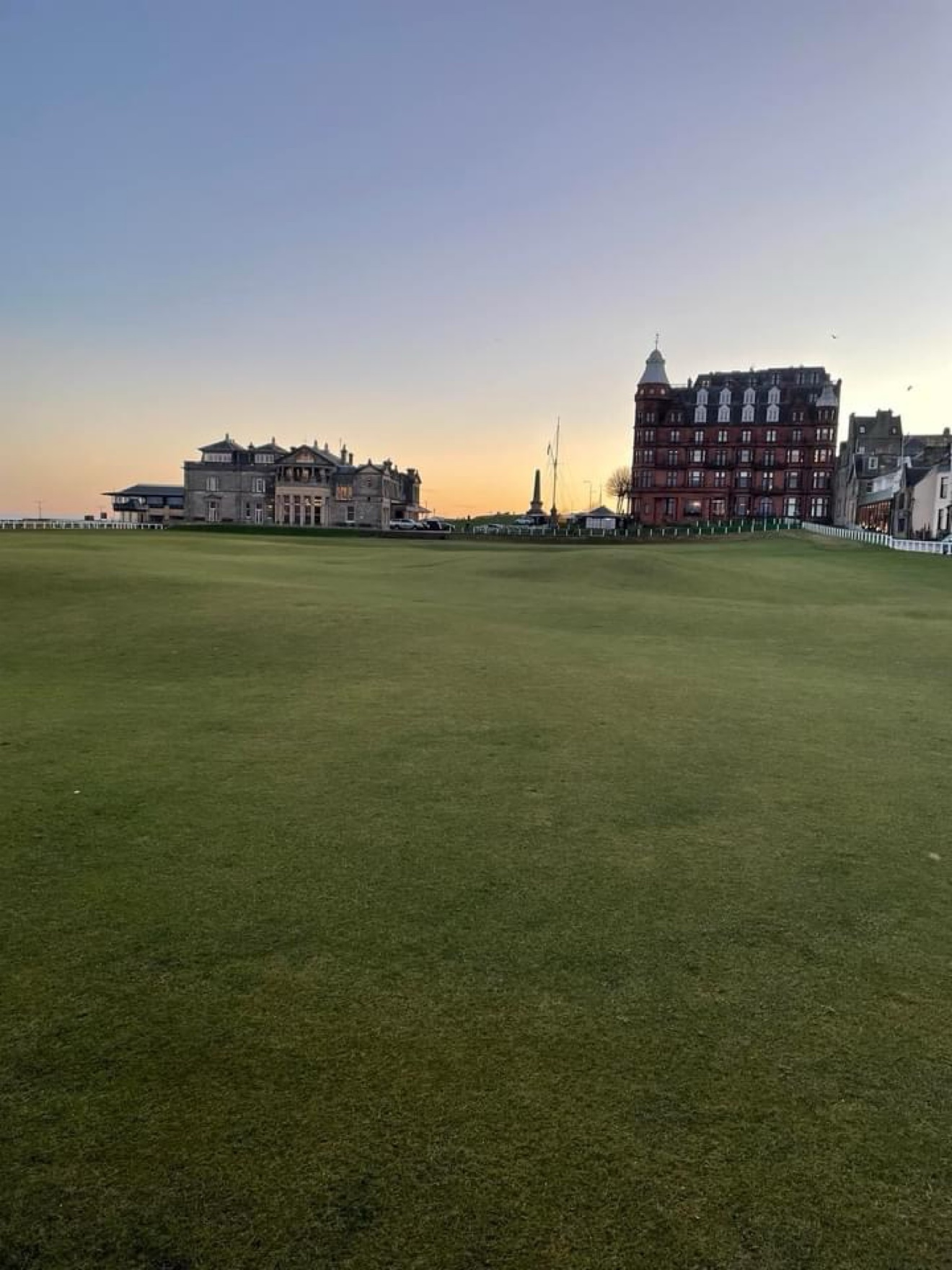 The Old Course at St Andrews at sunset with the R&A clubhouse and Hamilton Grand