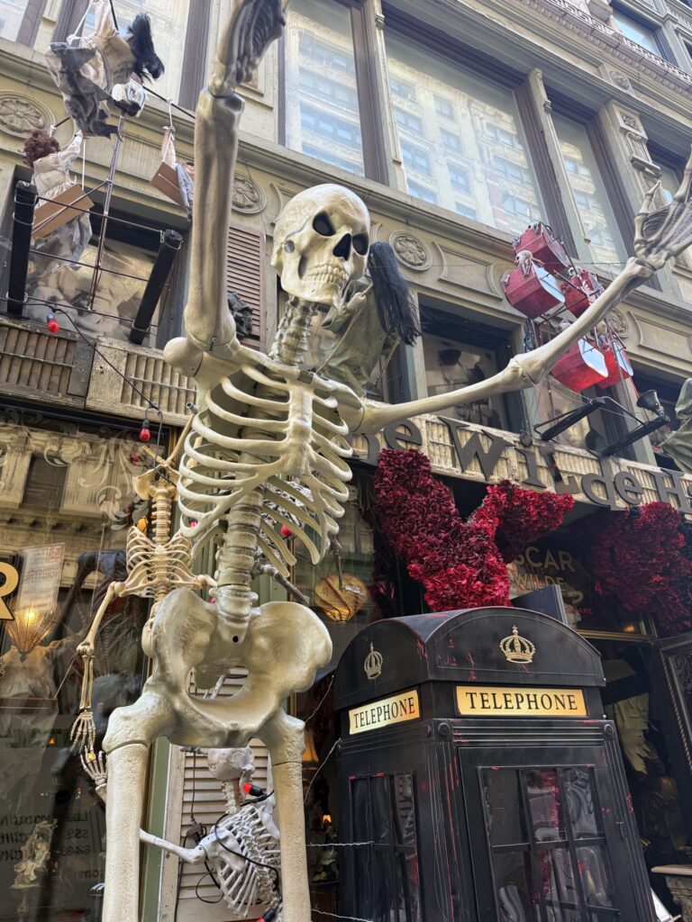 Oscar Wilde statue outside Oscar Wilde pub NYC with Halloween decorations