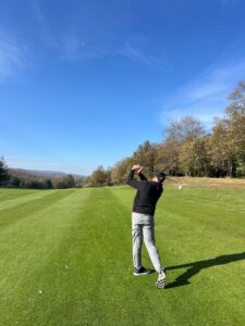 A golfer following through on a parkland fairway in northern Spain