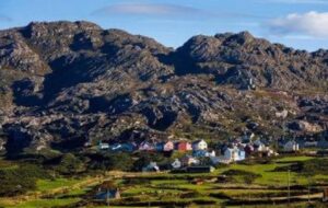 Colourful houses of a West Cork village beneath the Beara mountains