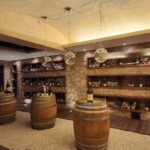 Italian wine cellar with oak barrels and bottles