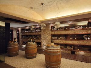 Italian wine cellar with oak barrels and bottles