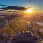 Aerial view of the Old Course at St Andrews at sunset, with the town, golf course and coastline, Scotland