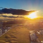 Aerial view of the Old Course at St Andrews at sunset, with the town, golf course and coastline, Scotland