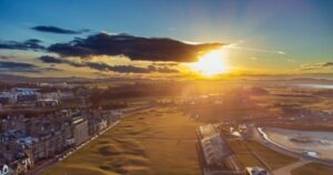 Aerial view of the Old Course at St Andrews at sunset, with the town, golf course and coastline, Scotland