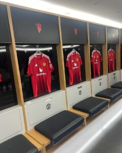 Manchester United shirts hanging in the home dressing room at Old Trafford
