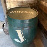 A green Jameson whiskey barrel