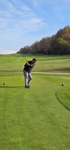 A golfer teeing off on a parkland course in northern Spain